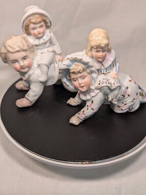 ANTIQUEGLAZED PORCELAIN GERMAN PIANO BABY s figurine